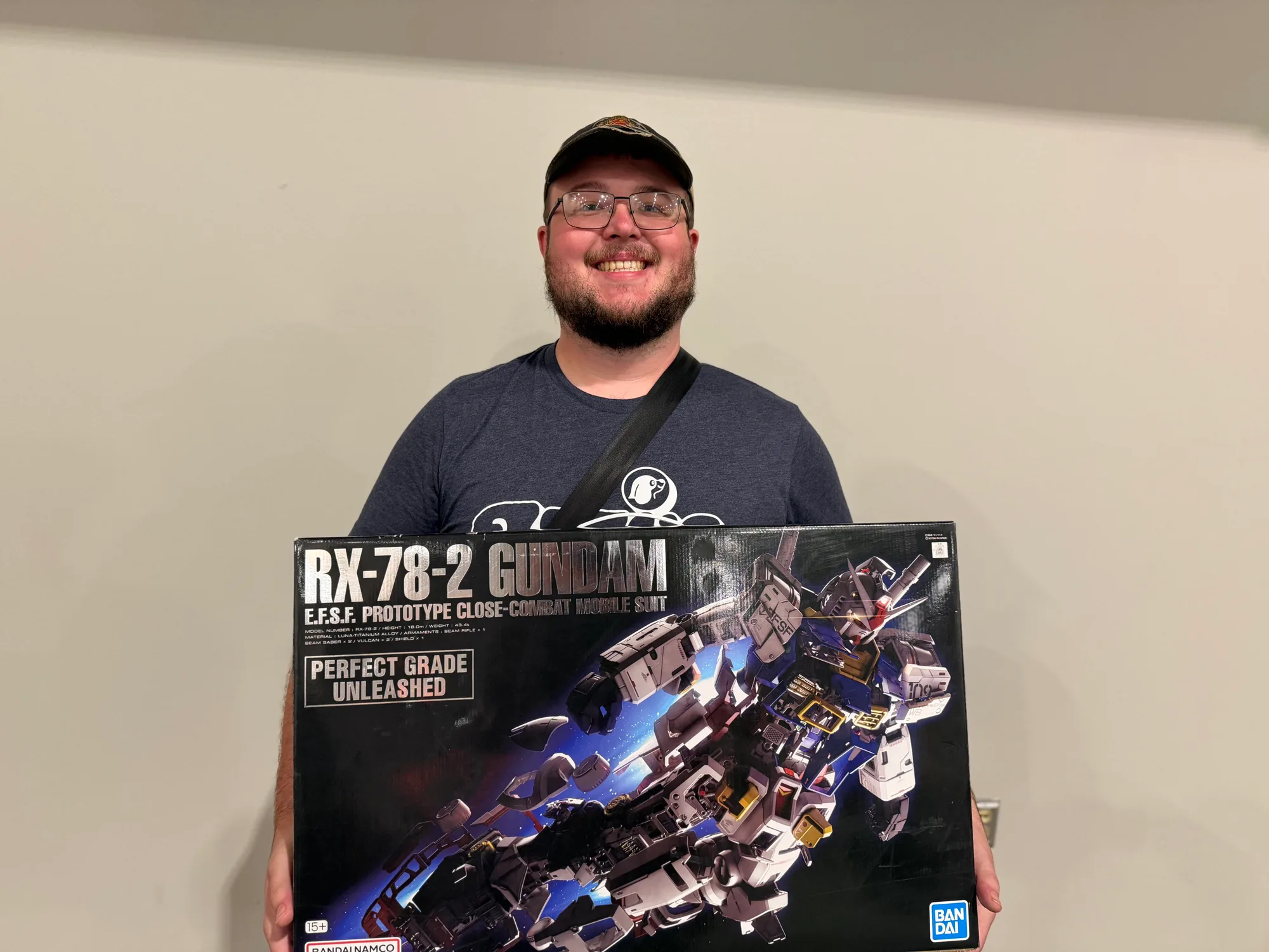 A club member holds a large RX-78-2 Gundam model kit box